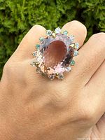 Ring on finger showing scale and gemstone colors