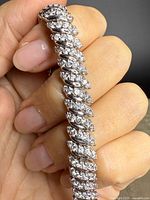 Close-up of bracelet links showing sterling silver and clear gemstones