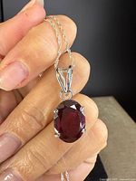 Close-up of garnet pendant showing stone cut, prongs and bail