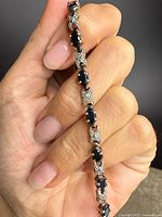 Close-up of bracelet showing sapphire and diamond link design