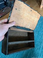 Lid opened showing interior compartments and notched joinery