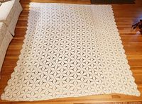 Full view of bedspread laid flat showing overall size and pattern