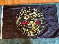 Full view of Cobra Kai flag laid flat