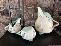 Three-piece Hull Butterfly ceramic set on display