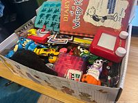 Shoebox filled with assorted toys, book and cards