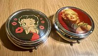 Closed pill boxes showing Betty Boop and Marilyn Monroe designs
