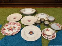 Group shot of all china pieces laid out on carpet