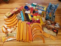 Full assortment laid out showing all track, playset parts and boxes