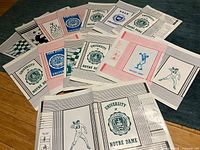 Spread of assorted university and graphic paper book covers laid flat on floor