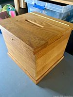 closed oak ballot box angled view showing slot and joinery
