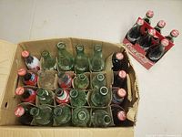 Top view of box showing 24 Coca-Cola bottles and separate sealed 6-pack