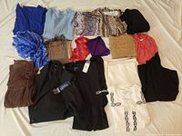 Full layout of all sixteen clothing items and scarves