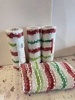 Four Celebrate It deco mesh rolls grouped; three wrapped, one unwrapped