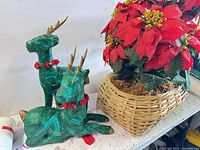 overall view of both reindeer and poinsettia basket