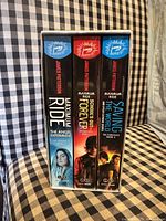 Front view of sealed 3-book boxed set showing spines and cover art