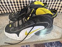 Side profile of both sneakers showing colorway, Swoosh and heel Air unit