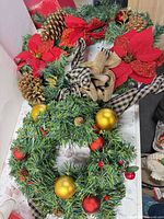 Both wreaths on tabletop showing overall decorations and size