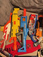 All five blasters laid out together on surface