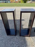 Two dark brown open tower shelves