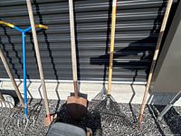 Lineup of tools showing cultivator, aerator, shovel, rake
