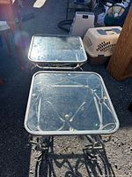 Both square glass side tables top view