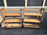 Front view of both folding shelf units fully opened showing four tiers each