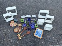 All items laid out showing shadow boxes, stones, ceramics, wood decor, trivet, horseshoe