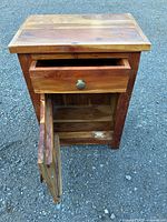 Front view showing drawer and open cabinet door