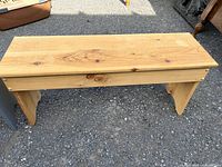 Natural finish wood bench front view