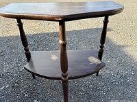 Full view of wooden two-tier side table showing top and lower shelf
