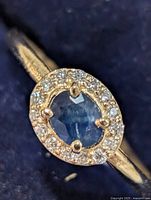 Front view of ring showing sapphire and moissanite halo