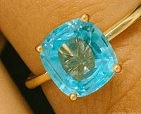Close-up of blue zircon and prong setting
