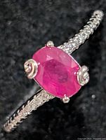 Top view showing oval ruby stone and CZ accents