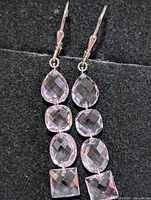 Full view of both silver amethyst dangle earrings