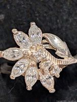 Top view showing floral marquise and round CZ cluster on silver ring