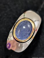 Top view of silver ring with oval tanzanite stone