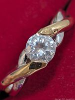 Close-up of ring front showing cubic zirconia and two-tone bypass design