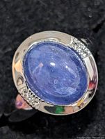 Front view showing oval tanzanite cabochon and topaz accents