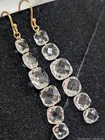 Front view of both earrings showing linked cushion-cut stones and hooks