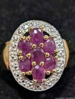 Top view of ruby cluster ring showing gemstones and halo