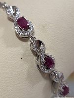 Infinity-link silver bracelet with rubies and CZ close-up