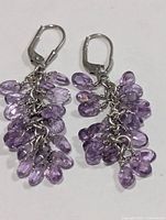 Front view of both earrings showcasing amethyst briolettes and silver leverbacks