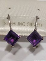 Front view showing both square amethyst earrings on sterling silver card