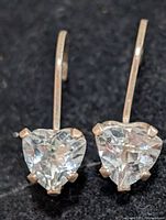 Front view of both silver leverback earrings showing heart-cut aquamarine stones