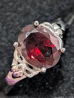Front view of ring showing oval garnet and prong setting