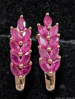 front view showing marquise ruby clusters on both earrings