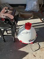 Cooler next to table holding binoculars and leather case