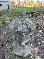 Full view of concrete pagoda in garden setting