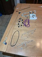 Full view of all necklaces and earrings laid on table
