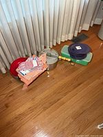 Group view showing popcorn popper, red bowl, Tupperware container, stack of collapsible bowls with lids, aprons, and oven mitts